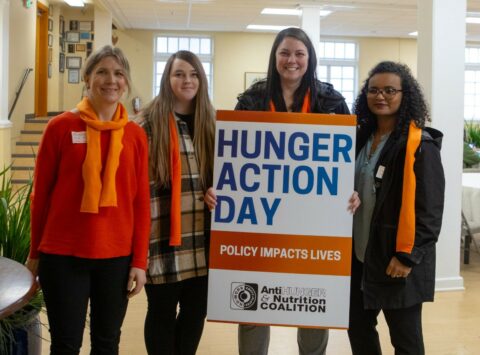 group of advocates hold up Hunger Action Day sign