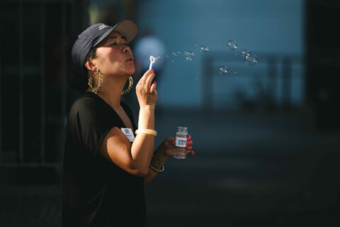 Northwest Harvest staff member blowing bubbles at KEXP event