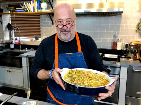Andrew Zimmern holding dish of tuna noodle casserole