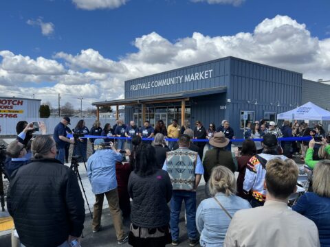 Northwest Harvest's Fruitvale Community Market in Yakima - image of crowd watching ribbon cutting on opening day