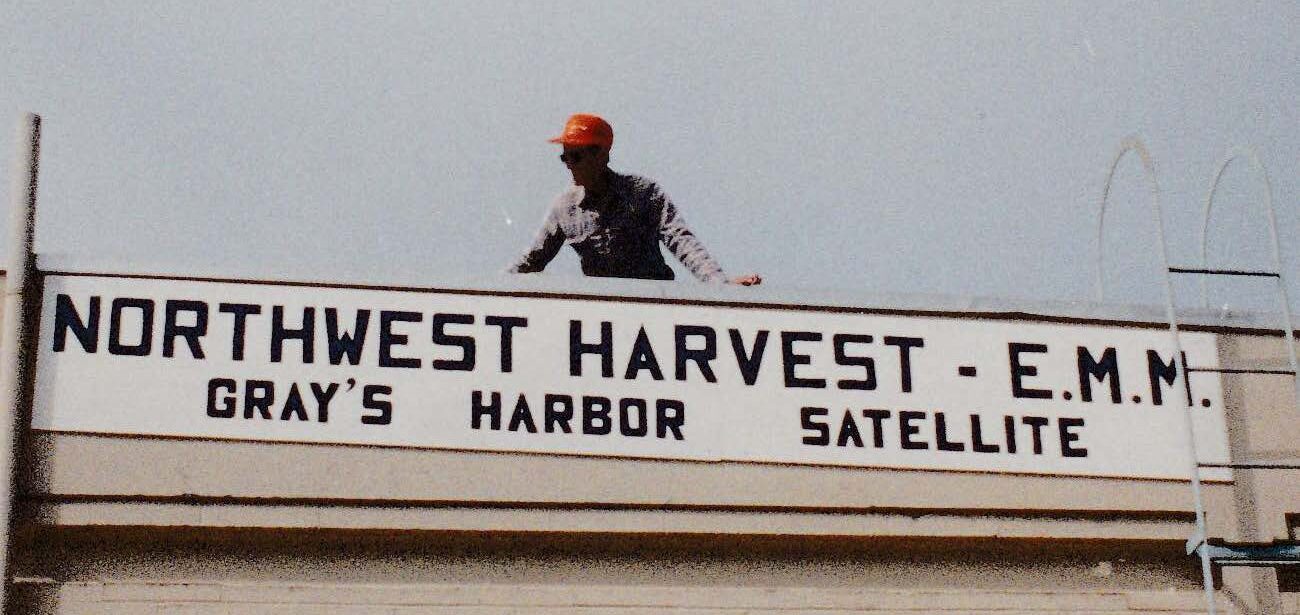 Vintage photo of person standing on roof of a food bank warehouse.