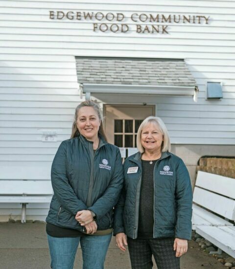 two Nourish staff members stand outside of Nourish Edgewood location