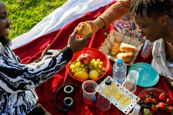 group of friends shares food at a picnic